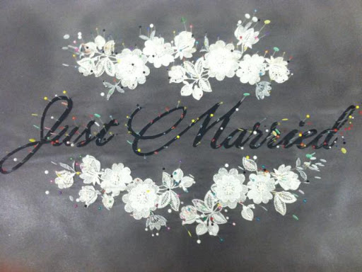 Lace applique and lettering pinned on paper