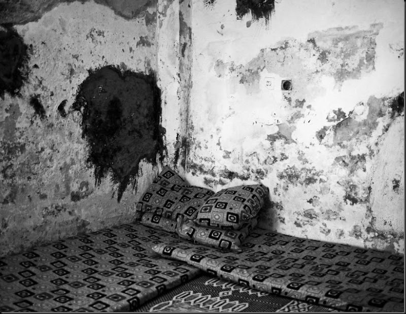 Thin mattresses and pillows used as beds inside a one-room apartment that houses an extended family of seven Syrian refugees in East Amman, Jordan. (Moises Saman/Magnum Photos for Save the Children)