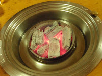 A waiter brought out red-hot charcoal and put it in the middle of the table.  I, foolishly, was sitting REEEALLY close to the grill.