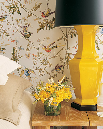 A yellow lamp with a black shade adds a bold element, while ecru and cream bedding, a blond-wood side table, and a jute rug temper the intensity of the walls, creating a balance of elements that's romantic but not predictable and feminine. A yellow lamp with a black shade adds a bold element, while ecru and cream bedding, a blond-wood side table, and a jute rug temper the intensity of the walls, creating a balance of elements that's romantic but not predictable and feminine.