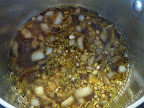 Spices, herbs, and seeds  simmer in the pan with the vinegar, onion, and garlic.
