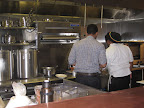 John getting some kitchen assistance from Michael.