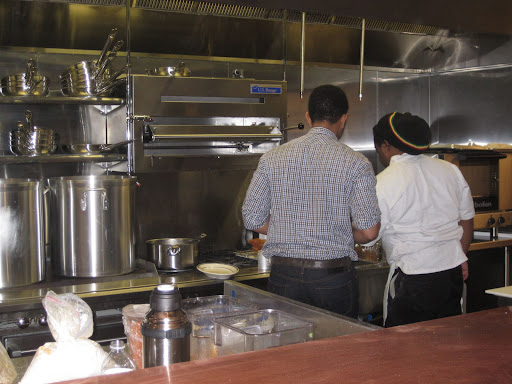 John getting some kitchen assistance from Michael.