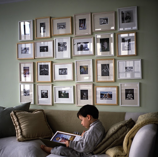 An unbound family album fills a wall. It is composed of inexpensive eight-by-ten-inch frames. The frames give consistency, while the pictures differ in size and style; some are horizontal, others vertical. Begin a grouping like this with one row or a minigrid of four frames.