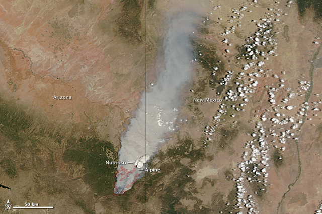 The Wallow Fire was well on its way toward becoming one of the largest fires in Arizona history when the Moderate Resolution Imaging Spectroradiometer (MODIS) on NASA&rsquo;s Aqua satellite took this image on June 4, 2011. Winds and hot, dry conditions helped the fire grow quickly in the week after it ignited on May 29. Red outlines the fire in this image. NASA image courtesy Jeff Schmaltz, MODIS Rapid Response Team at NASA GSFC