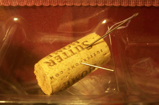 Stick pins and needles in the cork.