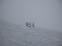 Morning of the climb. Talking to other climbers about conditions and their summit plan. They ended up bagging their summit attempt due to the bad weather and decided to head down.