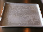 A greased pan, lined with parchment, with the parchment also greased.