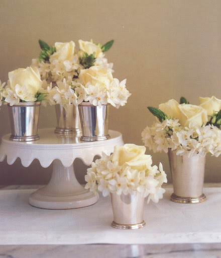 A five-part arrangement for a buffet uses paper-whites -- easy to force in winter -- roses, and ornithogalum in silver julep cups. (The Best of Martha Stewart Living -- Arranging Flowers)