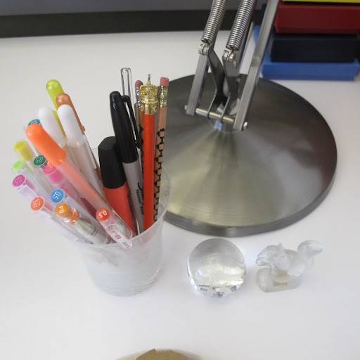 The squirrel paperweight was a gift from a friend. The sphere is from Lalique. My favorite pens are Hi-Tec. They are made in Japan and are super fine.