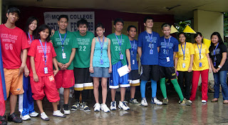 Team representatives pose on stage.