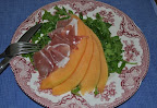 Cantaloupe and prosciutto over arugula
