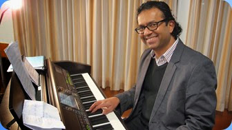 Our guest artist for the evening, International pianist, Ben Fernandez. Seen here setting-up the Club's Clavinova CVP-509. Photo courtesy of Dennis Lyons.