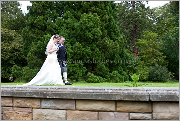 bride and groom walking round the gardens of carberry tower 