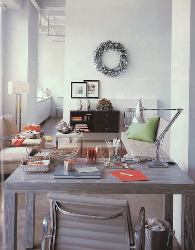 Metal chairs, lamps, and side tables refine this sleek loft space. The glittering hue bounces off a eucalyptus wreath and high-lights the faux-bois table.