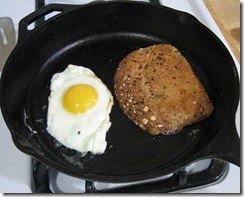 eggs and toast cooking in cast iron frying pan