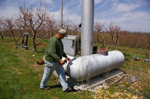 While the wind machine generates the wind, the smudge pots (rusty tanks in the background) generate the heat. The pots glow red when fully powered and the heat rising from them is circulated by the wind machine.