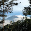 Gunung Wellirang smoking through the trees from PPLH