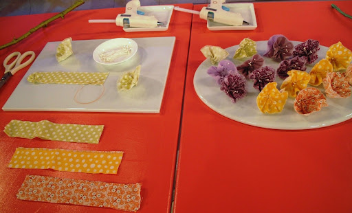 To affix the flowers to the branch, you simply glue them on. Of course, we use a Martha Stewart Crafts glue gun.