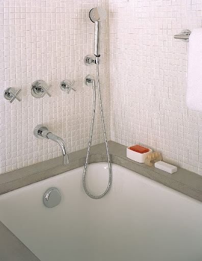 The bathroom counters are made of the same tinted plaster used in the kitchen. The tubs and sinks are undermounted, exposing the edge of the counter and making the surfaces easy to clean.