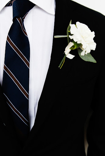 The groom wore Daniel Cremieux for Dillard's, and the boutonniere was created by contributing editor Matthew Robbins.