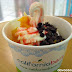 California Berry frozen yogurt with mango, crushed almonds and choco chips and drizzled with strawberry syrup