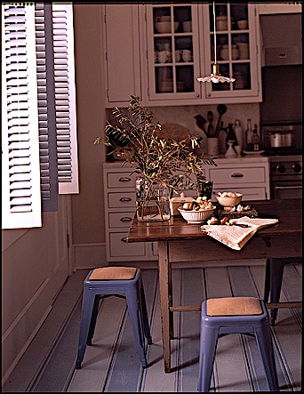 The alternating blue painted floor planks in this kitchen were inspired by a 19th Century dhurrie rug from India.