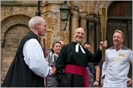 The Dean of Durham Cathedral tests out the torch before being lit.  John Attle