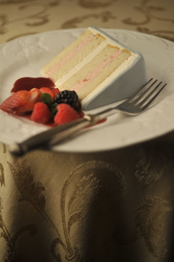 Take a look at the inside of the confection: ThisTahitian vanilla cake, with alternating layers of strawberry mousseline and French vanilla, is finished off with meringue buttercream and gray Swiss fondant.