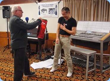 MC for the evening, Laurie Conder, presenting Taka with a couple of bottles of wine as a token of the Club's appreciation for his Concert - sometimes money cannot compensate for the six months practise to ensure near perfection! Photo courtesy of Dennis Lyons.