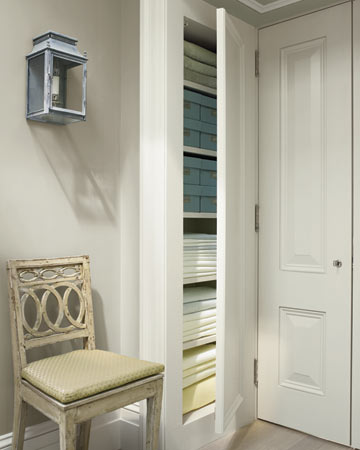 A linen closet, inconspicuous behind double doors leading into the bedroom, is just deep enough to hold sheets and other necessities. A linen closet, inconspicuous behind double doors leading into the bedroom, is just deep enough to hold sheets and other necessities.