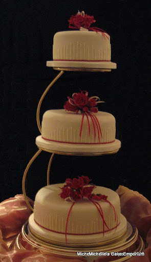 Elegant 3 tier wedding cake with deep red sugar roses
