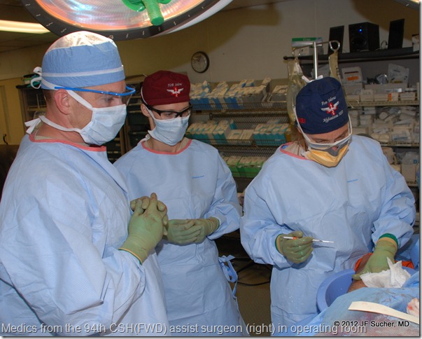 Medics from the 94th CSH(FWD) assist surgeon (right) in operating room