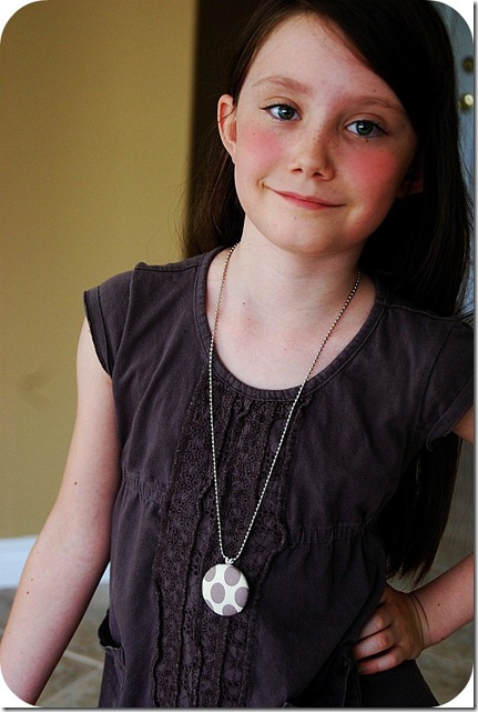 ella wearing covered button necklace