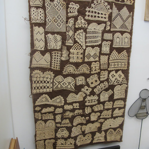 Fritz uses this vintage crochet sampler from the late 19th century as a wall hanging.