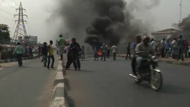 Tires burn in the street as protesters in Lagos, Nigeria march against the removal of fuel subsidies, 3 January 2012. BBC