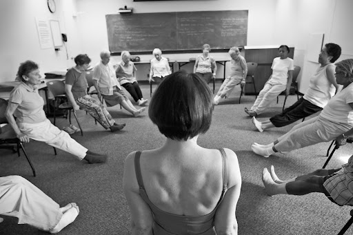 Deborah Quilter leads a chair yoga class