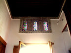 The main bedroom, which he lent to me to sleep in(!) - when the morning sun strikes them, the windows glow like jewels