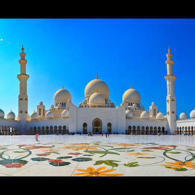 The biggest mosque in the United Arab Emirates, and one of the biggest in world able to hold a capacity of 40,000 Muslims in prayer, the Sheikh Zayed Mosque is an architectural masterpiece.No matter where you face, in the courtyard or inside, each arch lines up, each dome is symmetrical, each line is perfect.Completed during Eid al-Adha in 2007, the $500 million mosque is now home to the grave after which the mosque is named, Sheikh Zayed, the first ruler of the modern United Arab Emirates.It is also home to the world's largest chandelier and the world's largest rug. (And if I may say, the chandelier is pretty grand and beautiful... but the rug? I prefer the one in the Sultanahmet Mosque in Istanbul, Turkey :P) And the material that lines the courtyard is so magnificently white, it blinds you in the Emirati sun.Hands down, the best mosque I've ever been to... so far.<br> © Asim Bharwani<br> 5220096083.jpg