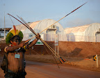 Indigenous man with bow and arrow in front of the occupied construction site