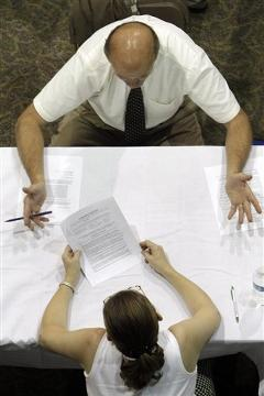 In this 25 August 2010 file photo, a job applicant receives advice on his resume while attending a job fair in Southfield, Mich. Nearly all states provide up to 26 weeks of unemployment benefits. During the recession, Congress added up to 73 extra weeks in states with especially high unemployment. As a result, up to 99 weeks of benefits are available in 22 states and up to 93 weeks in four other states. Paul Sancya / AP Photo / file