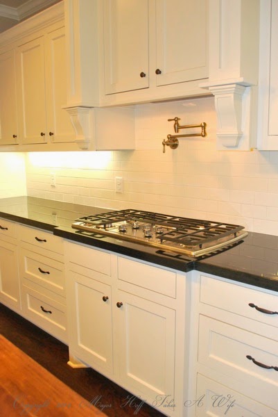 Traditional white kitchen stove area with water spout.jpg Traditional white kitchen stove area with water spout