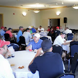 Golfers enjoy snacks and stories before the announcement of the winner in the KNIA/KRLS Golf Classic