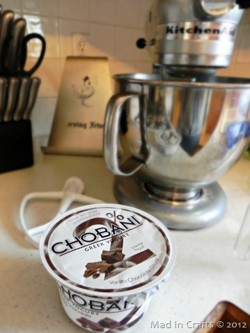 container of chocolate Greek yogurt in front of a KitchenAid mixer