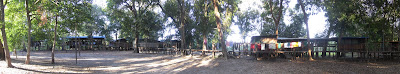 Multi-shot panorama of our campsite. Our cabin was off to the left, roughly in the middle was the kitchen and dinning area with the campfire in front of it and the place behind the washing line was the bar with the river just past it.