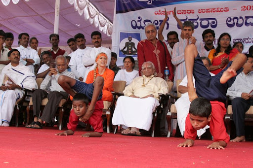 1. Mr. BKS Iyengar watching, with a look of discontent, as blind children perform overly rigorous postures near the Mysore Palace.