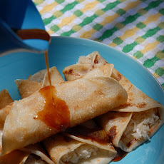 Patishapta- Indian crepe with cardamom coconut filling, drizzled with date syrup