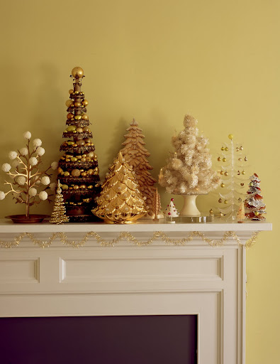 unusual and handmade trees mix with discount-store products on a mantel. The tallest is made from tin-can lids and a broomstick, and is decorated with gold balls. unusual and handmade trees mix with discount-store products on a mantel. The tallest is made from tin-can lids and a broomstick, and is decorated with gold balls.
