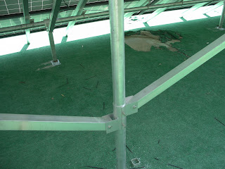 The 3" aluminum slider brackets used for the diagonal bracing.  The square aluminum tubing is cut to length, drilled for bolt attachment and secured. This is done for the front to rear bracing as well. Front to rear bracing uses the special post top bracker that secures horizontal conduit and the square tubing.