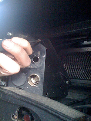 Unscrewing the existing console which supports only a couple of cigar lighter sockets.